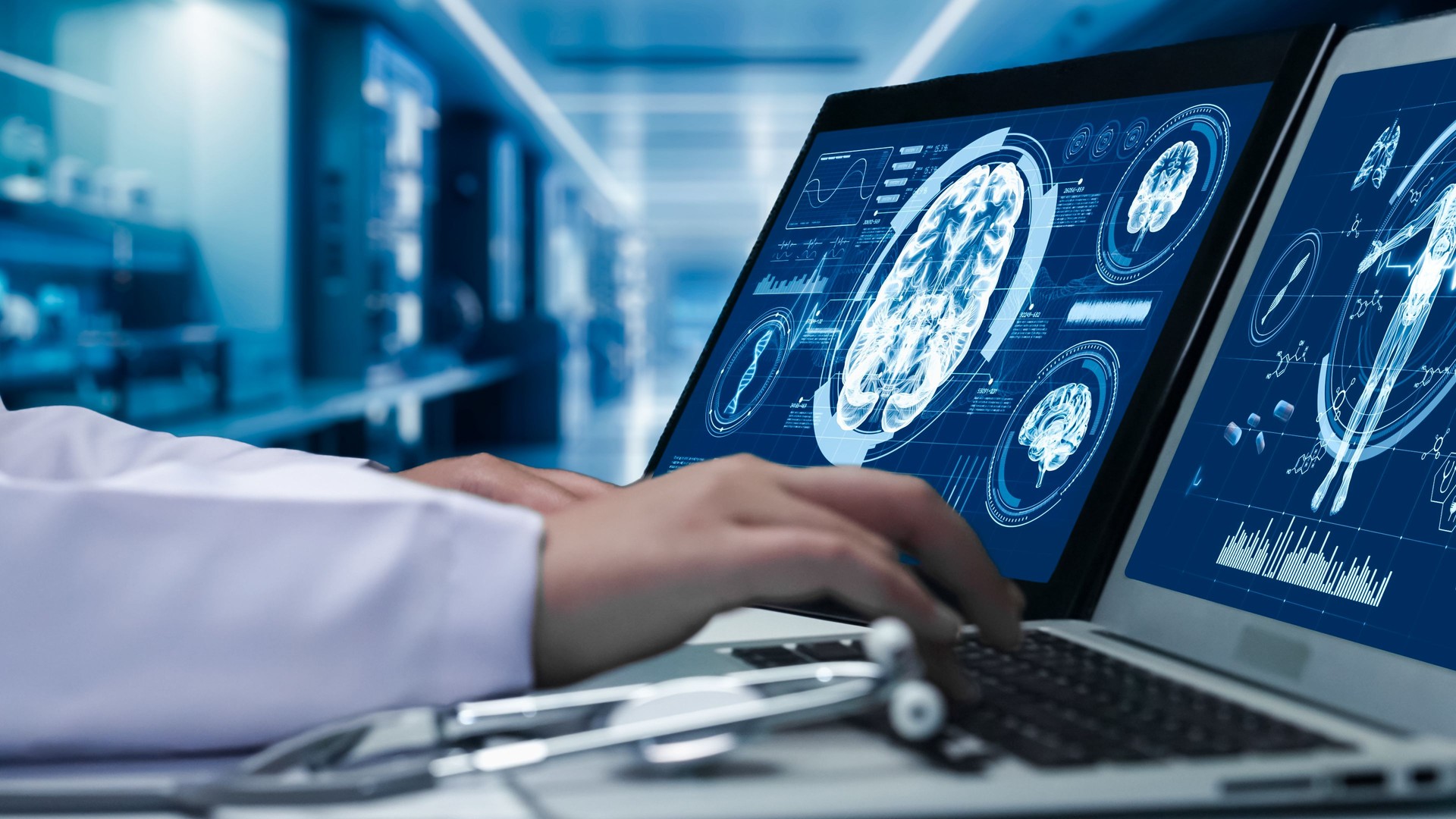 Close up of doctor working on tablet and laptop with brain anatomy. Remedial.